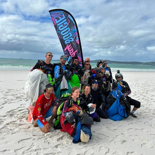 skydivers posing for a photo on a Whitsundays beach