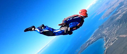 AFF skydiving student flying over Airlie Beach coastline