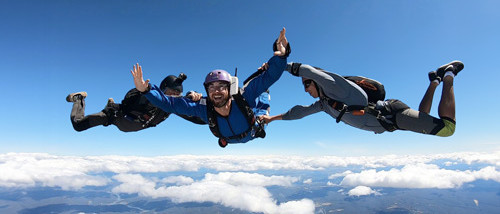Skydiving student in freefall with 2 instructors doing AFF Stage 1 in Australia