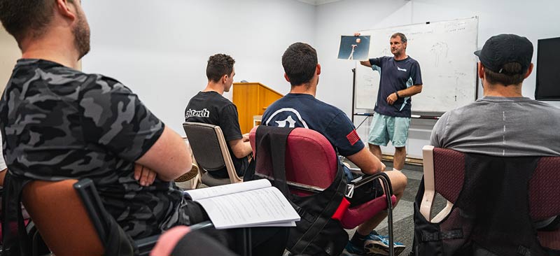 Students learning about skydiving malfunctions with SKYONE Sydney