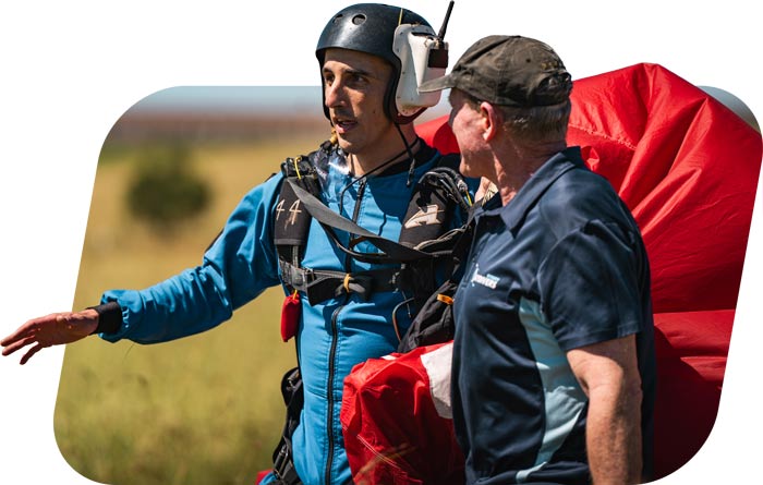 AFF student with skydiving instructor after landing a parachute