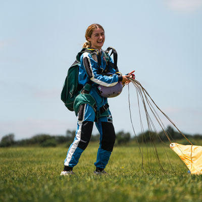 Australian skydiving student on the ground right after landing her parachute