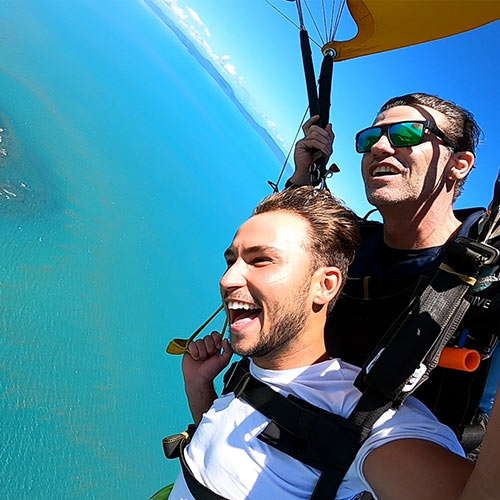 tandem skydiving passenger steering parachute in airlie beach