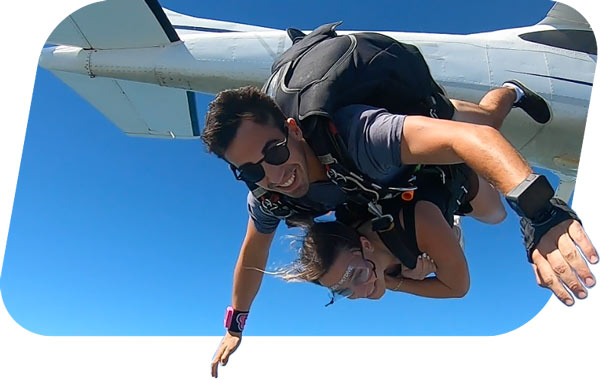 skydiving instructor taking video of passenger over airlie beach