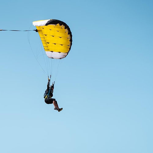 Experienced licensed skydiver flying a parachute