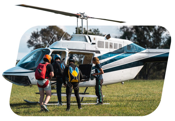 Licensed skydivers boarding a helicopter