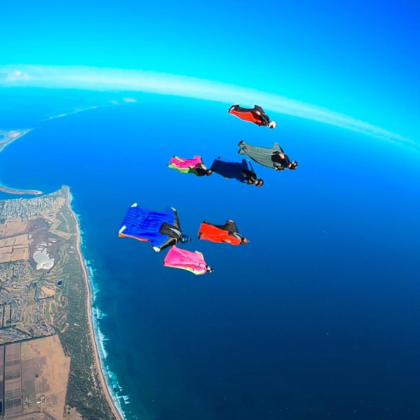 Skydivers flying wingsuits over the Great Ocean Road Melbourne