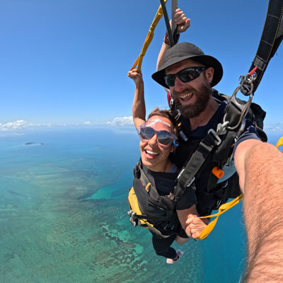 Skydiving instructor and passenger flying a parachute over Kings Reef in the Great Barrier Reef Queensland