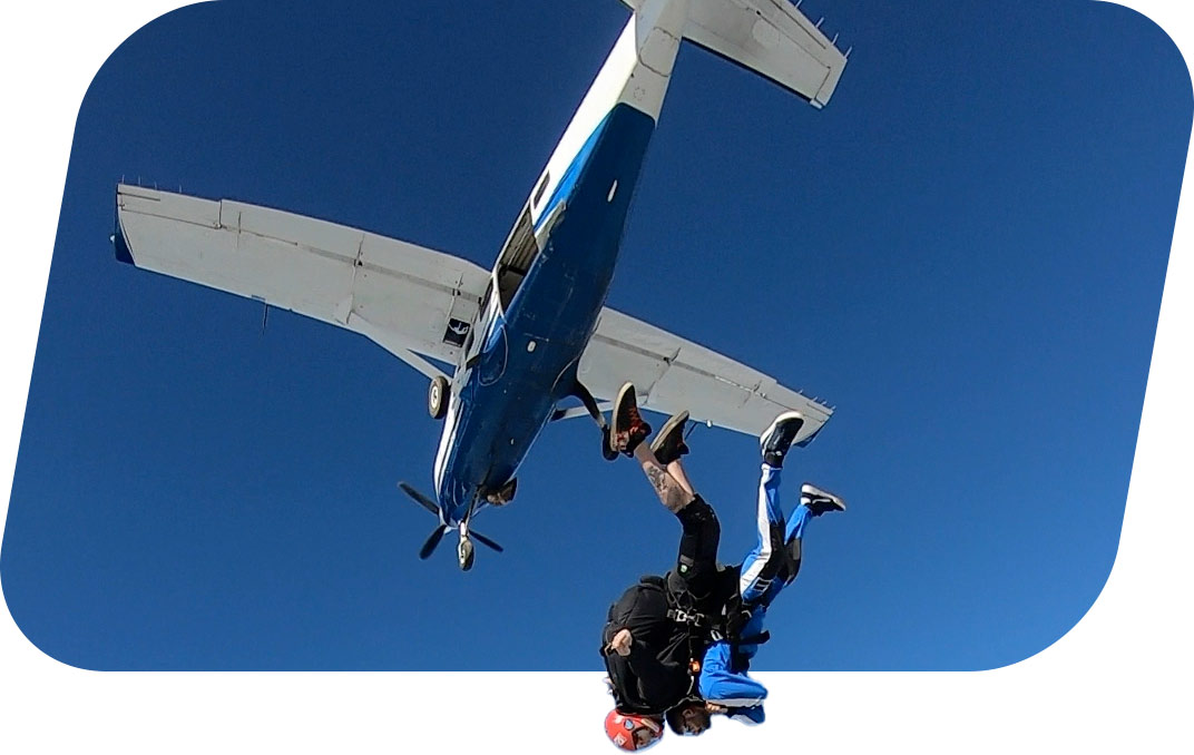Tandem skydive pair jumping out of plane