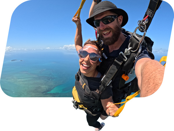 Skydiving passenger steering the parachute over the Great Barrier Reef