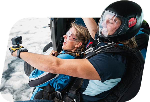 Skydiving instructor and passenger on the edge of the plane