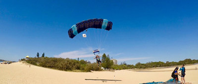 tandem skydiving instructor and passenger landing on Currimundi Beach in Sunshine Coast