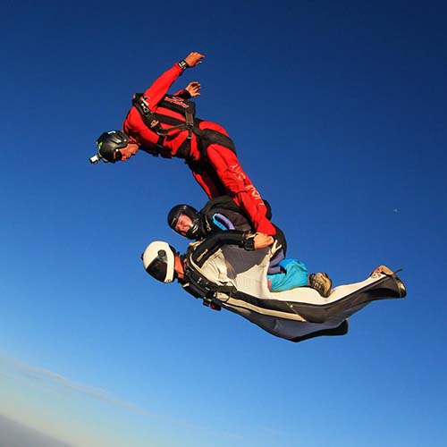 Licensed skydivers freefalling over the Great Ocean Road