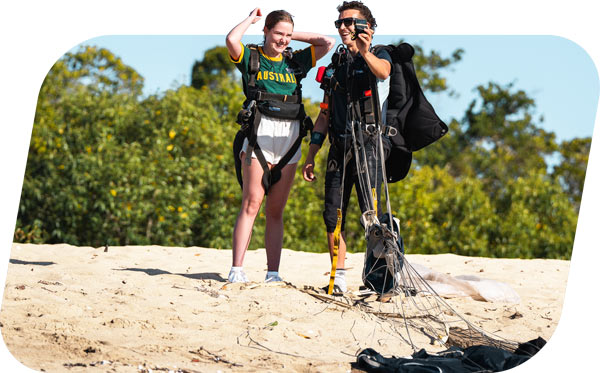 Skydiving Airlie Beach instructor filming customer on the beach