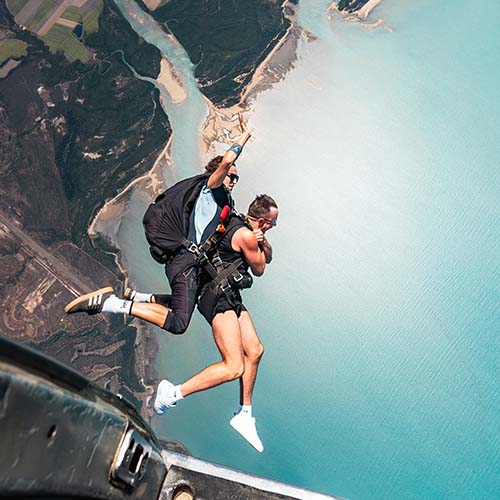 skydivers jumping over Airlie Beach Whitsundays