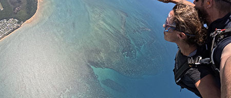 skydiving customer in freefall looking over the Great Barrier Reef in Cairns