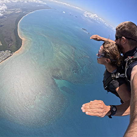 skydiving customer in freefall looking over the Great Barrier Reef in Cairns
