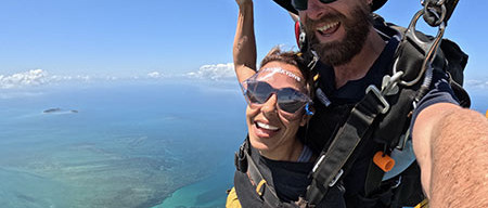 skydiving passenger steering parachute over Cairns