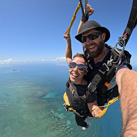 skydiving passenger steering parachute over Cairns
