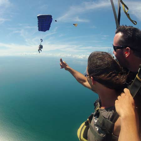 skydiving instructor and tandem passenger under canopy