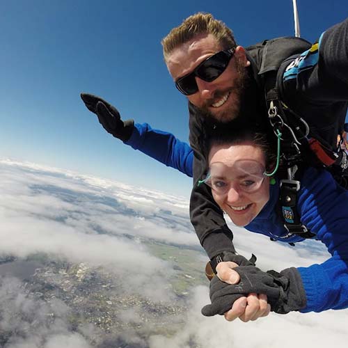 Customer in freefall with skydiving instructor over Canberra