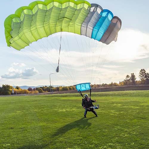 Skydiving instructor and customer landing under parachute over Deakin Oval Canberra
