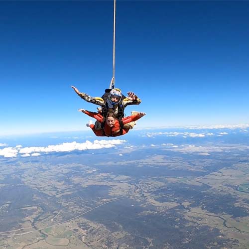 Tandem skydiving pair in freefall over the Hunter Valley