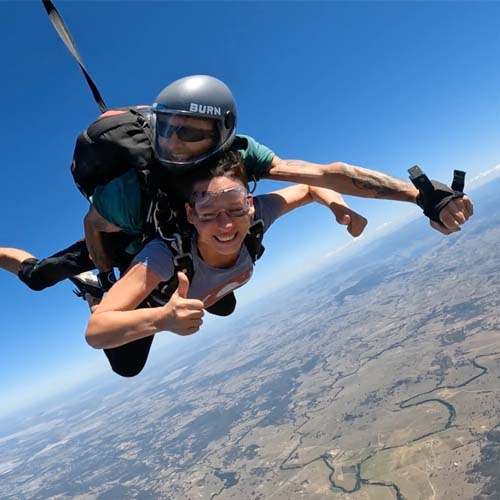 Tandem skydiving pair in freefall over the Hunter Valley