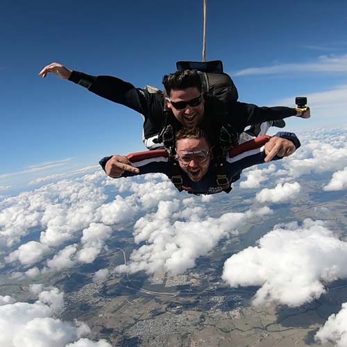Tandem skydiving pair in freefall over the Hunter Valley