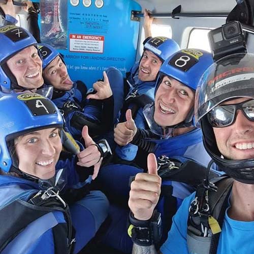 Skydiving instructor and students in plane