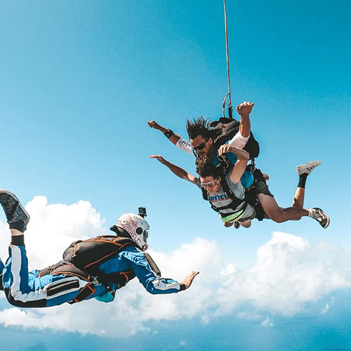 skydiving outside camera filming tandem skydiving passenger