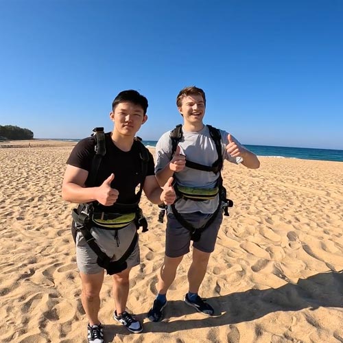 skydiving customers posing for a photo on currimundi beach sunshine coast