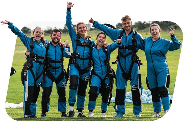 skydiving sydney customers celebrating on the ground after their skydive