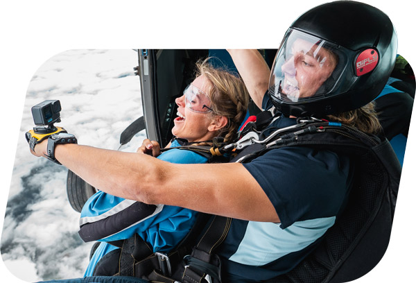 instructor filming passenger skydiving