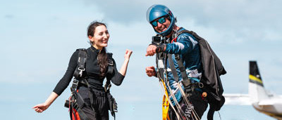 Customer posing for a video filmed by skydiving instructor