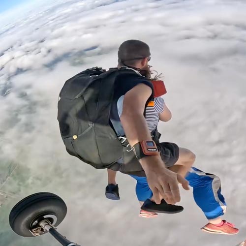 Tandem skydiving pair exiting plane over Townsville
