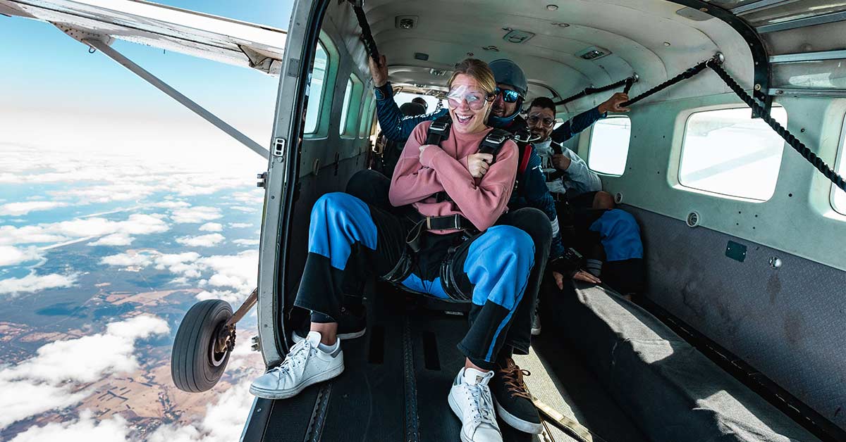 customer and skydiving instructor about to exit plane